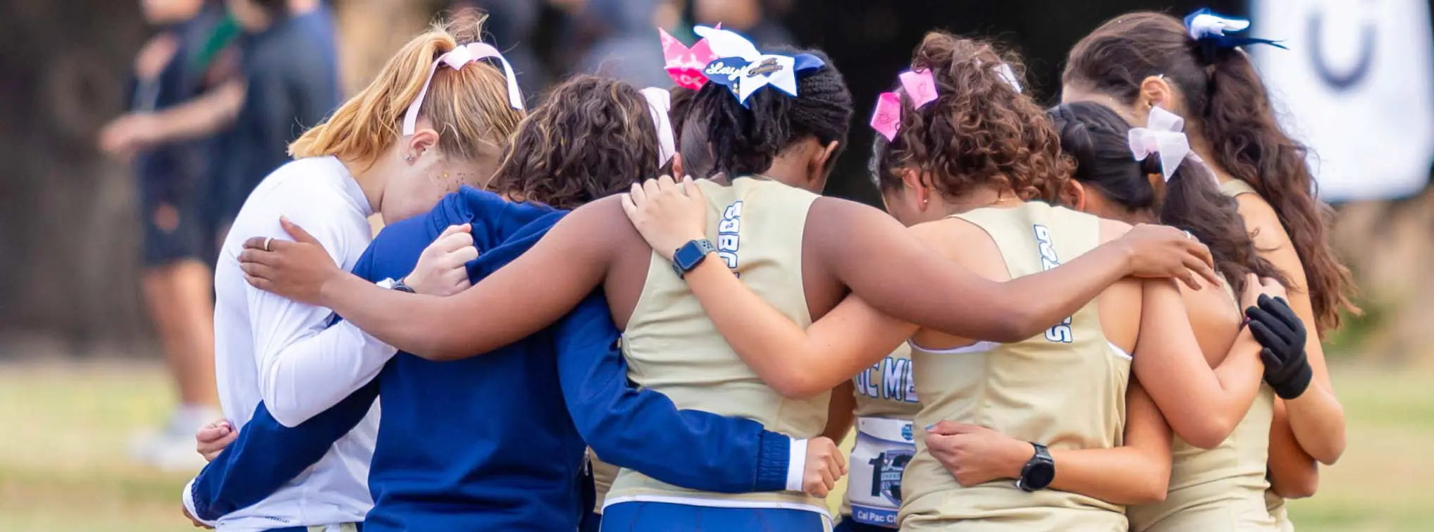 Women with arms around each other in a huddle